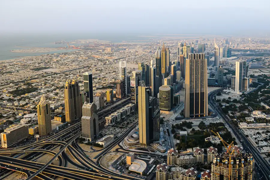 Modern glass office building reflecting Dubai skyline